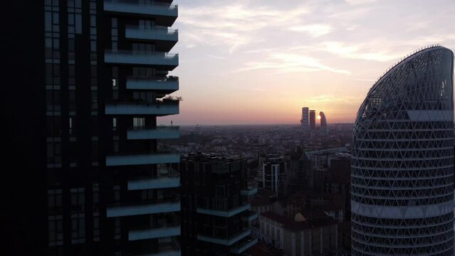 Milan aerial view at sunset - skyline between two skyscrapers in the Isola/Bosco Verticale area. City Life in the distance.