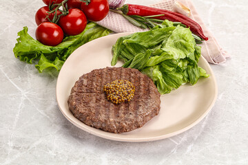 Frilled beef burger cutlet with iceberg