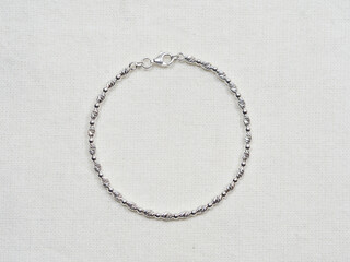 Silver bracelet display on white cloth background