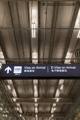 E Visa on arrival signage concept at airport for tourists. Visa sign in English and Chinese in airport