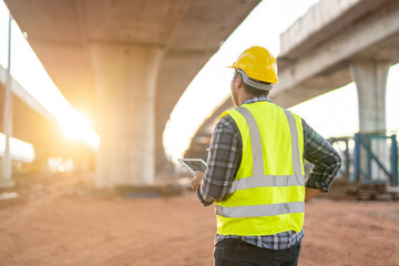 A civil engineer or supervise inspected the structure road at new road construction.