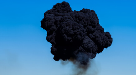 black smoke very polluting and carcinogenic on the background of the blue sky