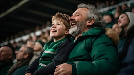 Cercles muraux Europe du nord Irish father and son in stands, filled with enthusiastic supporters of rugby or football team wearing green clothes to support national sports team