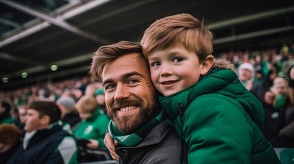 Irish father and son in stands, filled with enthusiastic supporters of rugby or football team wearing green clothes to support national sports team - obrazy, fototapety, plakaty
