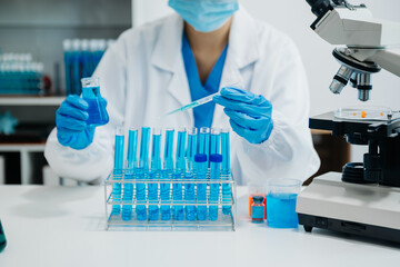 Fototapeta premium Modern medical research laboratory. female scientist working with micro pipettes analyzing biochemical samples, advanced science chemical laboratory