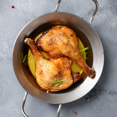 Freshly roasted duck legs confit in oven pan, top view	 - 662168631
