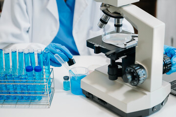 Modern medical research laboratory. female scientist working with micro pipettes analyzing...