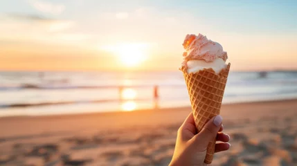 Foto auf Alu-Dibond A hand holding a melting ice cream cone at the beach © Cloudyew