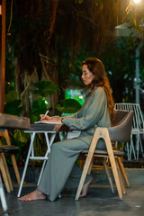 Freelance woman working in café at the evening