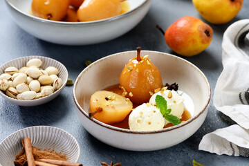 Poached pears with spices in syrup and  ice cream balls . Delicious dessert.