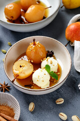 Poached pears with spices in syrup and  ice cream balls . Delicious dessert.