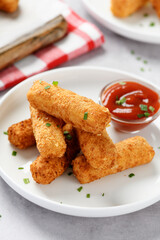 Breaded fried mozzarella cheese sticks with tomato  dipping sauce.