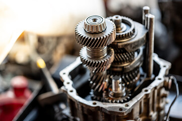 Disassembled car automatic transmission gear part or gearbox on workbench in auto repair shop. Fix and maintenance vehicle part service in the garage. Mechanical engineering and automotive industry - 662193692