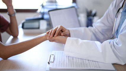 Asian psychologist women holding hand to encouraging patient and giving counseling about mental health therapy in clinic while female patient stress and anxiety with psychological health problem - obrazy, fototapety, plakaty
