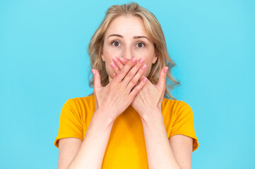 Portrait of surprised young woman. Don't want to tell secret - obrazy, fototapety, plakaty