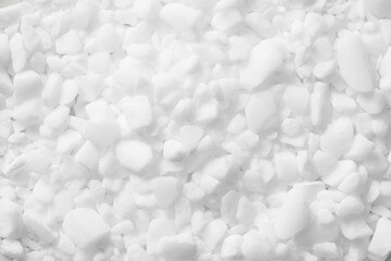 Coarse grain salt. Dishwasher salt texture. Granulated crystalline sodium chloride. Closeup grains. White granules background. Chemistry dry additive. Granular closeup.