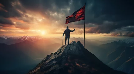 Fotobehang Silhouette of a man with his flag waving in the wind on the top of mountain with a morning sky and sunrise and enjoys the moment of success. © KikkyCNX