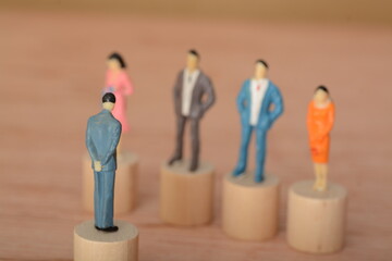 The businessman, standing in a row with his team, listened carefully as the boss led a discussion...