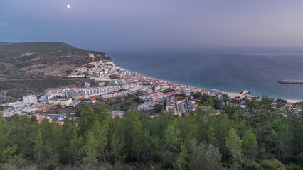 Fototapeta na wymiar Aerial view of the coastline of the village of Sesimbra day to night timelapse. Portugal