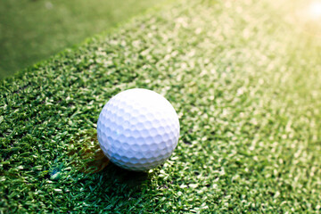 Golf ball placed on artificial grass.