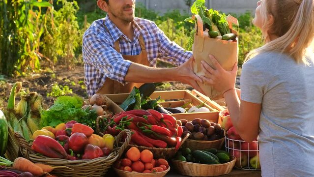 Man and woman at a farmers market. Selective focus. - Powered by Adobe