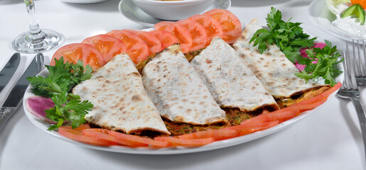 Turkish lahmacun kebap, one of the most important dishes of Turkish cuisine