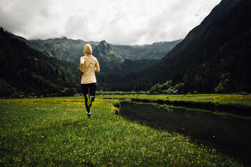 Woman trail runner cross country running in beautiful nature