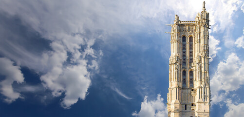 Saint-Jacques Tower (Tour Saint-Jacques) against the background of a beautiful sky with clouds. Located on Rivoli street, Paris, France. This 52 m Flamboyant Gothic tower (XVI century) - obrazy, fototapety, plakaty