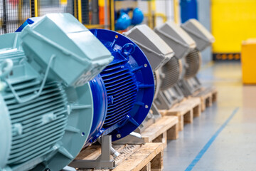 new electric motors different colors and sizes on pallets in the warehouse in factory - obrazy, fototapety, plakaty