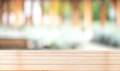 empty wooden table on background of abstract blur white interior, montage, product display, inside and window.