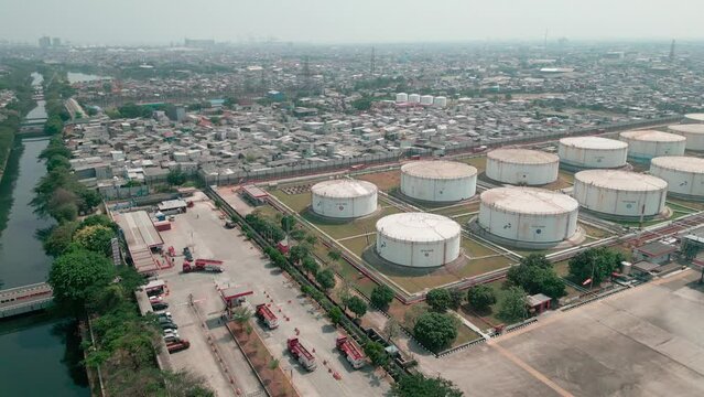 Aerial view of oil storage tanks near crowded residential in Plumpang, North Jakarta