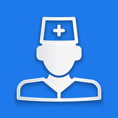 Paper cut Male doctor icon isolated on blue background. Paper art style. Vector