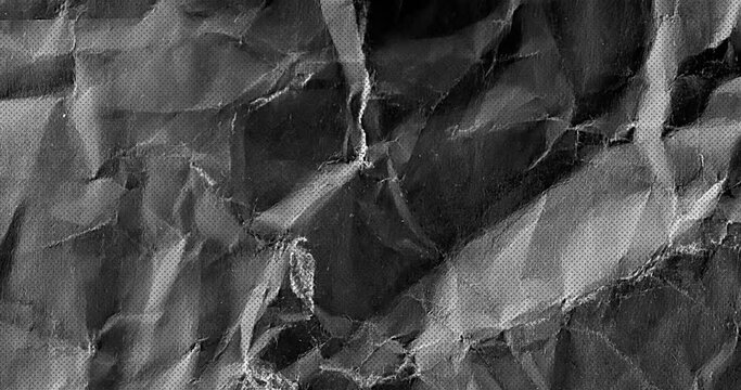 Black color Grunge noise texture of a textured crumbled paper surface stop motion animation. Hard creased Crumbled paper grungy stop motion animation seamless looped.