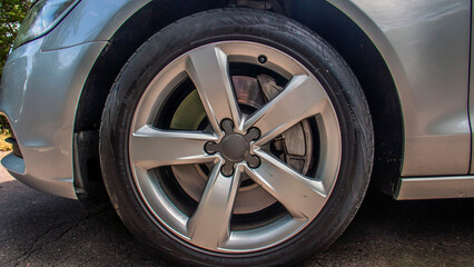 Gray car rim on the wheel of a gray car