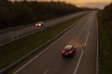 Blurred photography of cars motion in a highway at sunset