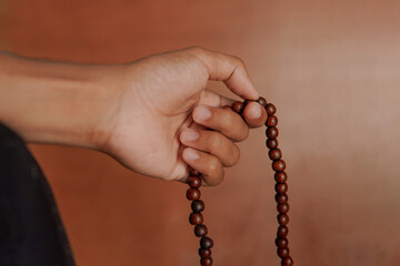 muslim hand holding a prayer beads or tasbih