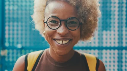 Foto op Plexiglas Close up, woman in glasses, dressed in brown top looking at camera smiling broadly © Andrii Nekrasov