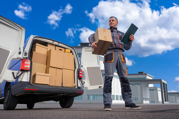 Male courier. Guy next to delivery service minivan. Courier holding box and clipboard. Delivery man...