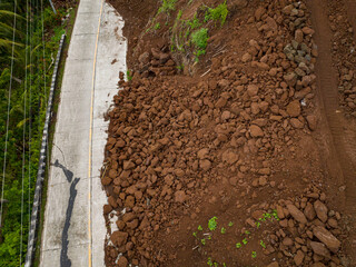 Camiguin Island: Aerial view of mud and rocks blocking the road after rain. Landslides with rocks...