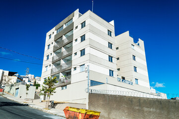 Beautiful residential building on blue sky background. Dump for rubble. Horizontal.