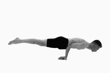 Mayurasana (Peacock Posture), Ashtanga yoga  Side view of man wearing sportswear doing Yoga exercise against white background.  Black and white image. - obrazy, fototapety, plakaty