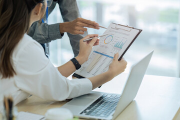 accountant team with laptop and paperwork analyzing financial data report