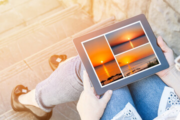 Lady holding tablet pc with colorful pictures of sunrise over the sea, image with effect of sunlight  flash