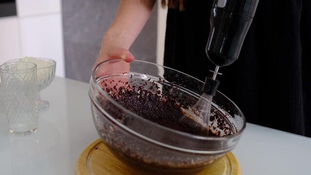 mixed yolk eggs, flour and sugar prepare for baking cake or bake. Process of making brownie. Stirring ingredients in a glass bowl.