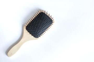 Wooden Paddle Hair Brush on white background, top view.