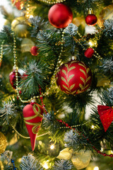 Red baubles and decorations on christmas tree for background. New Year concept.