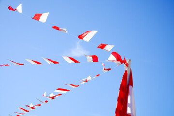 Red and white paper decorations hung from the background of blue sky to welcome Indonesia's...