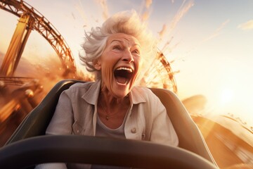 Portrait of a happy senior woman on the roller coaster with dawn sunset sky background. - obrazy, fototapety, plakaty