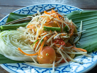 somtam food papaya fruit vegetable veganerie siam thai table desk wood asian bean salad lime eating...