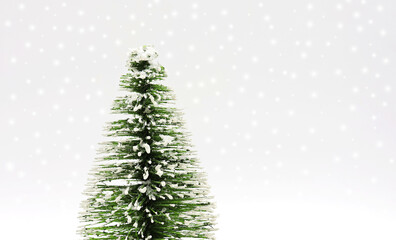 Christmas tree isolated on a white snowy background . Greeting card for Christmas and New Year....
